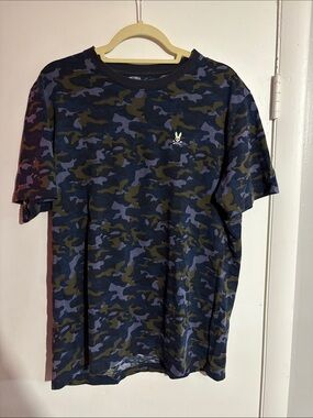 Psycho Bunny woman’s Navy & Olive Camo Short Sleeve Tee. Aria casino logo.